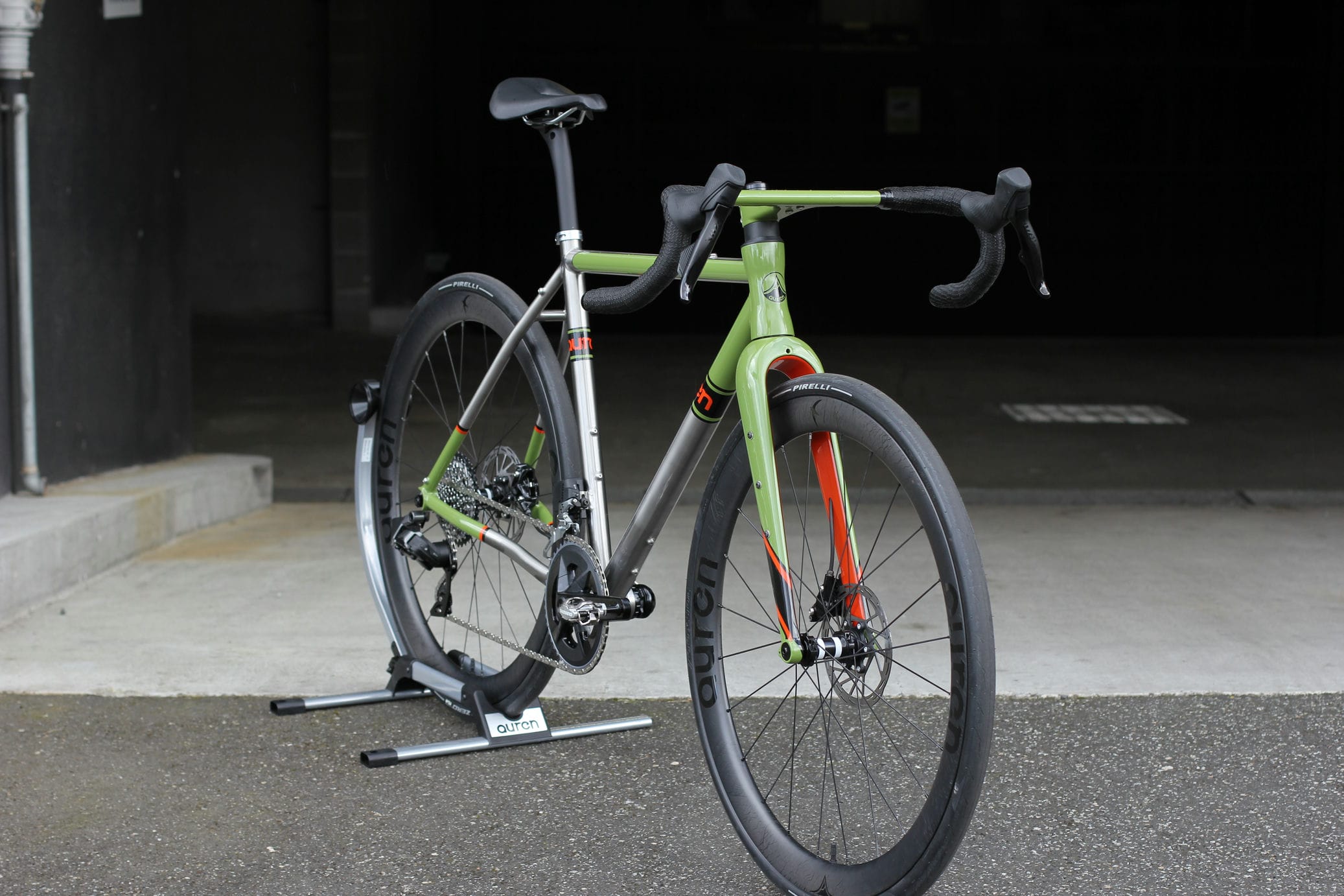 Auren titanium road bike with a green painted finish and a one-piece integrated cockpit