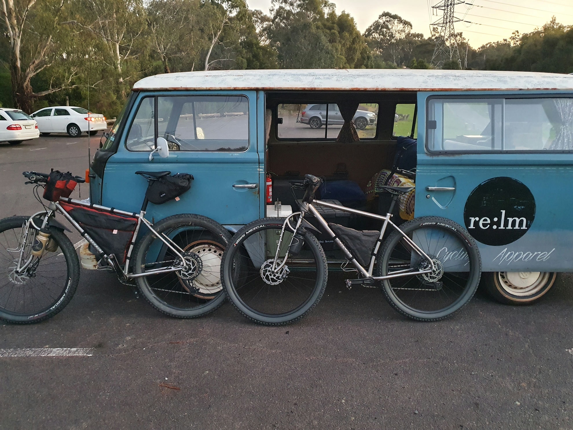 Two Auren titanium bikes leaning on a Kombi van