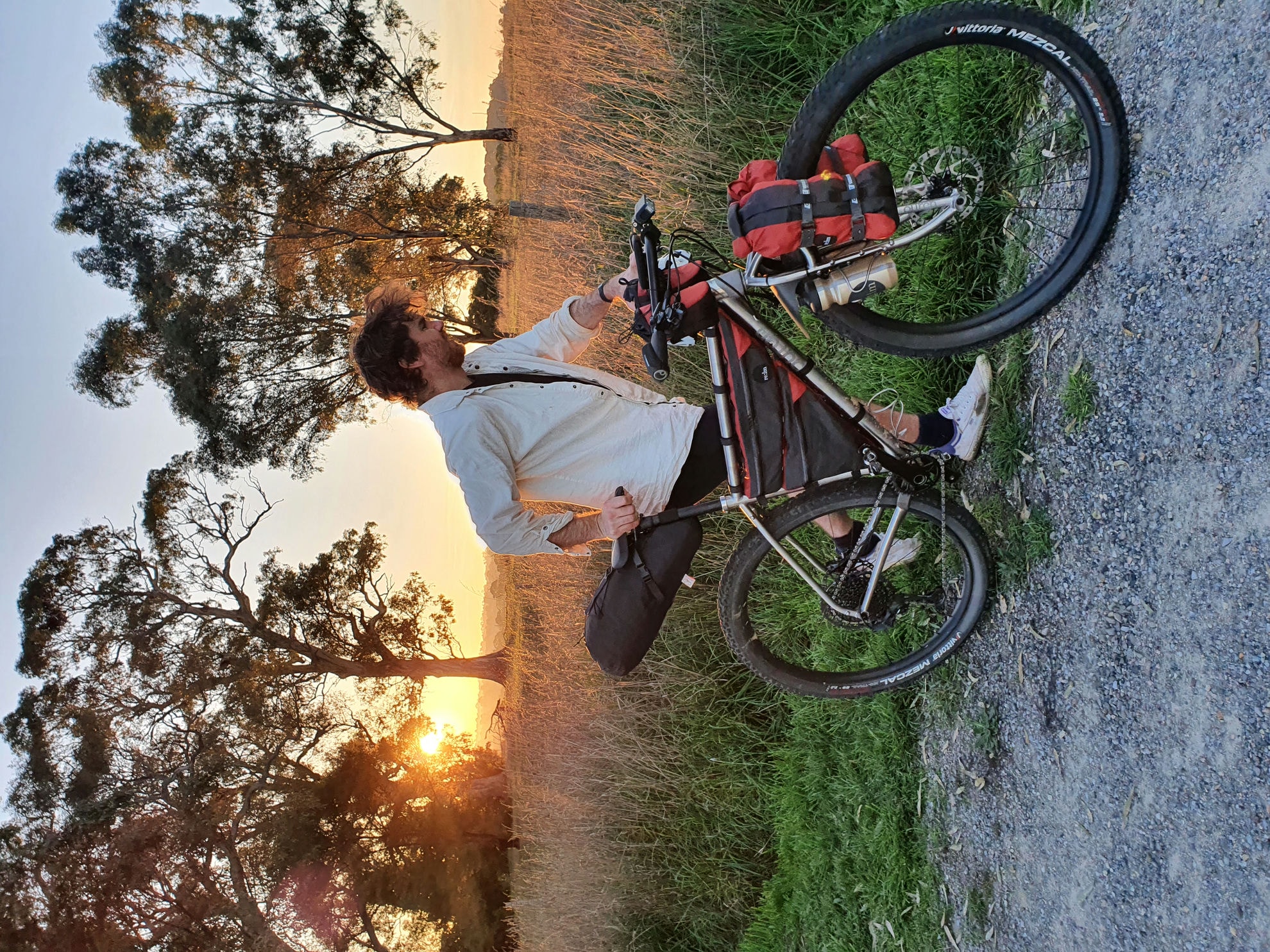 Evan with his loaded Auren titanium bike at sunset
