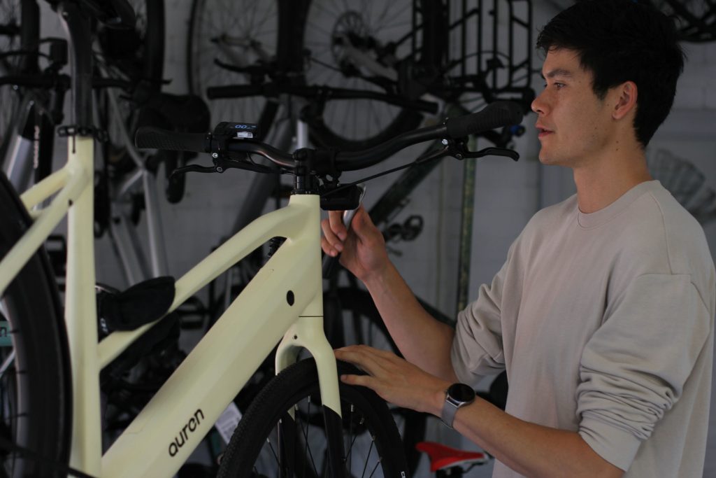 Will at the Auren EV5 handlebar, with the cables routed into the frame