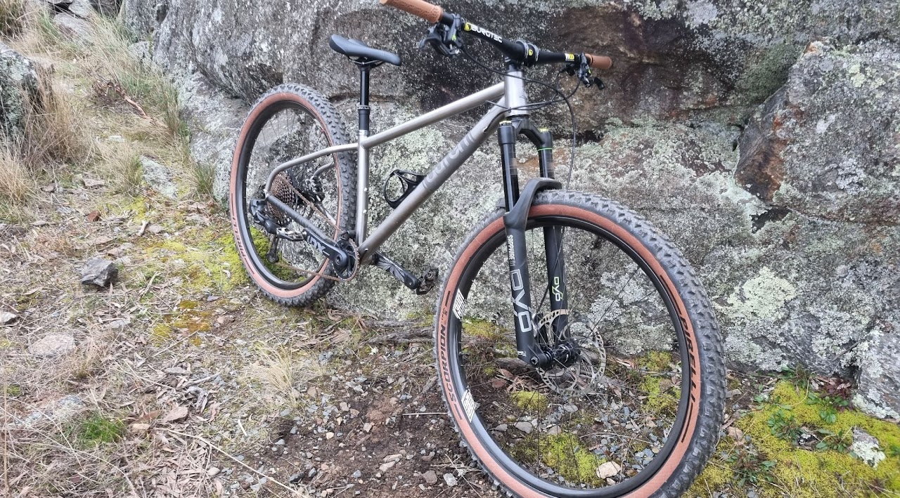 An Auren titanium hardtail built with Pilot Bike Co, on a rock slab