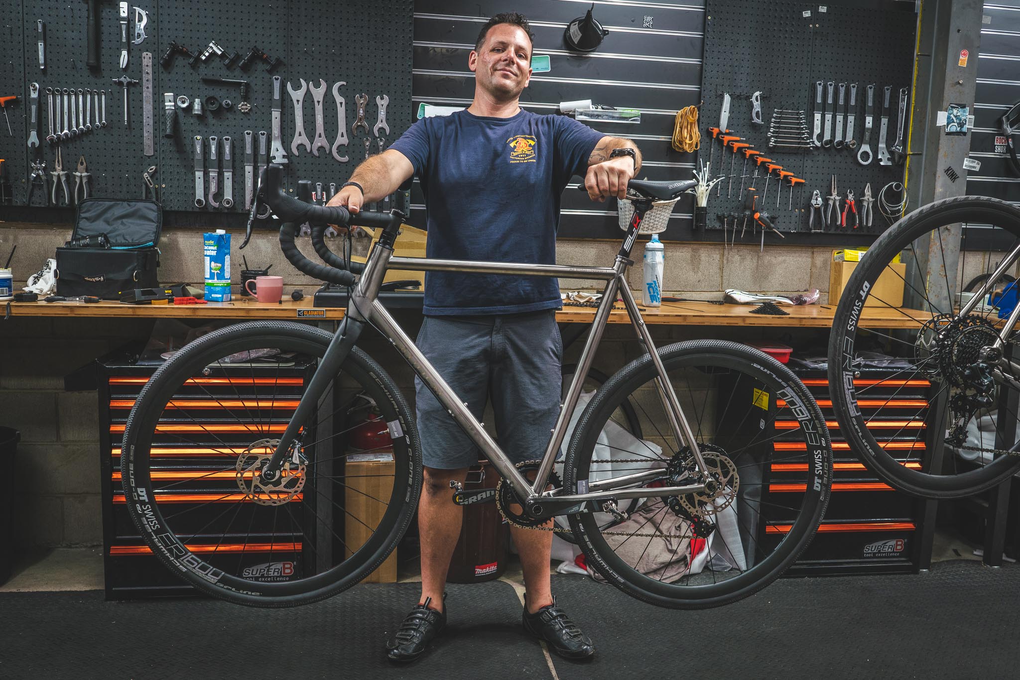 Dave holding up his finished Auren titanium bike in the workshop