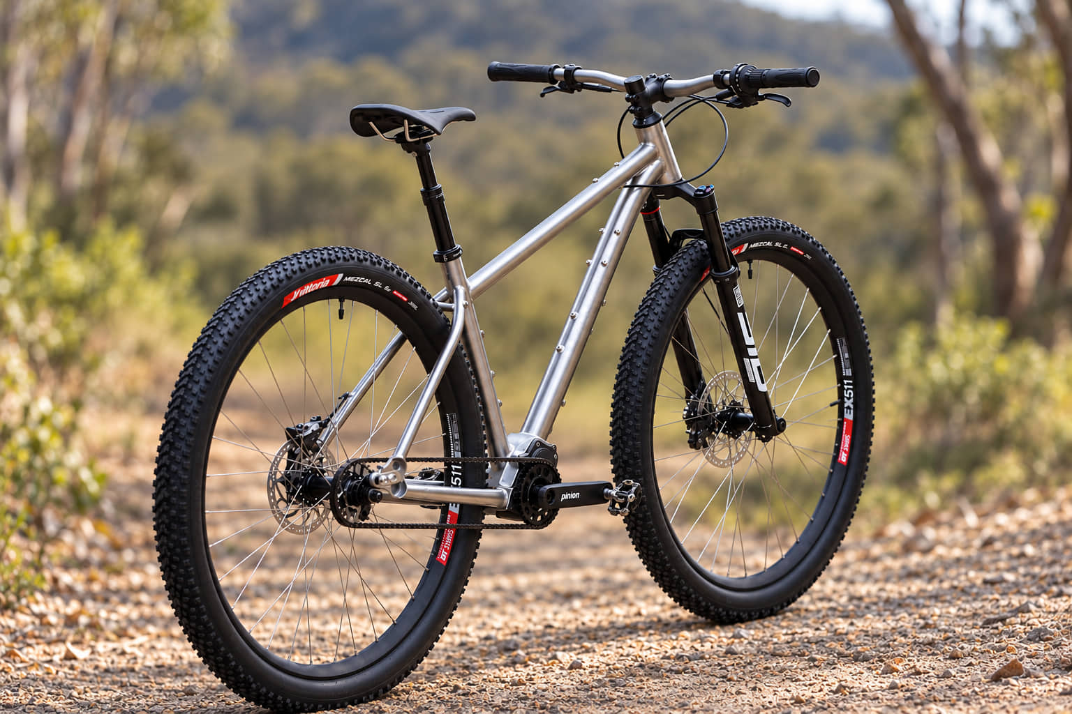 An Auren titanium hardtail on a gravel track in bushland